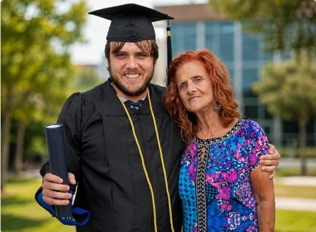 Sherman Easley-Robb in cap and gown with his mother, Cynthia Robb, outside at his University of Houston-Clear Lake graduation.