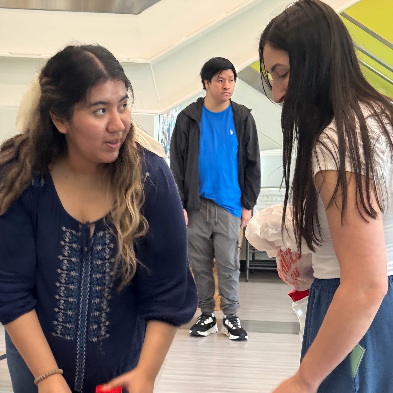 Diana Mendoza, Alex Nguyen, and Annie Jones behind the scenes